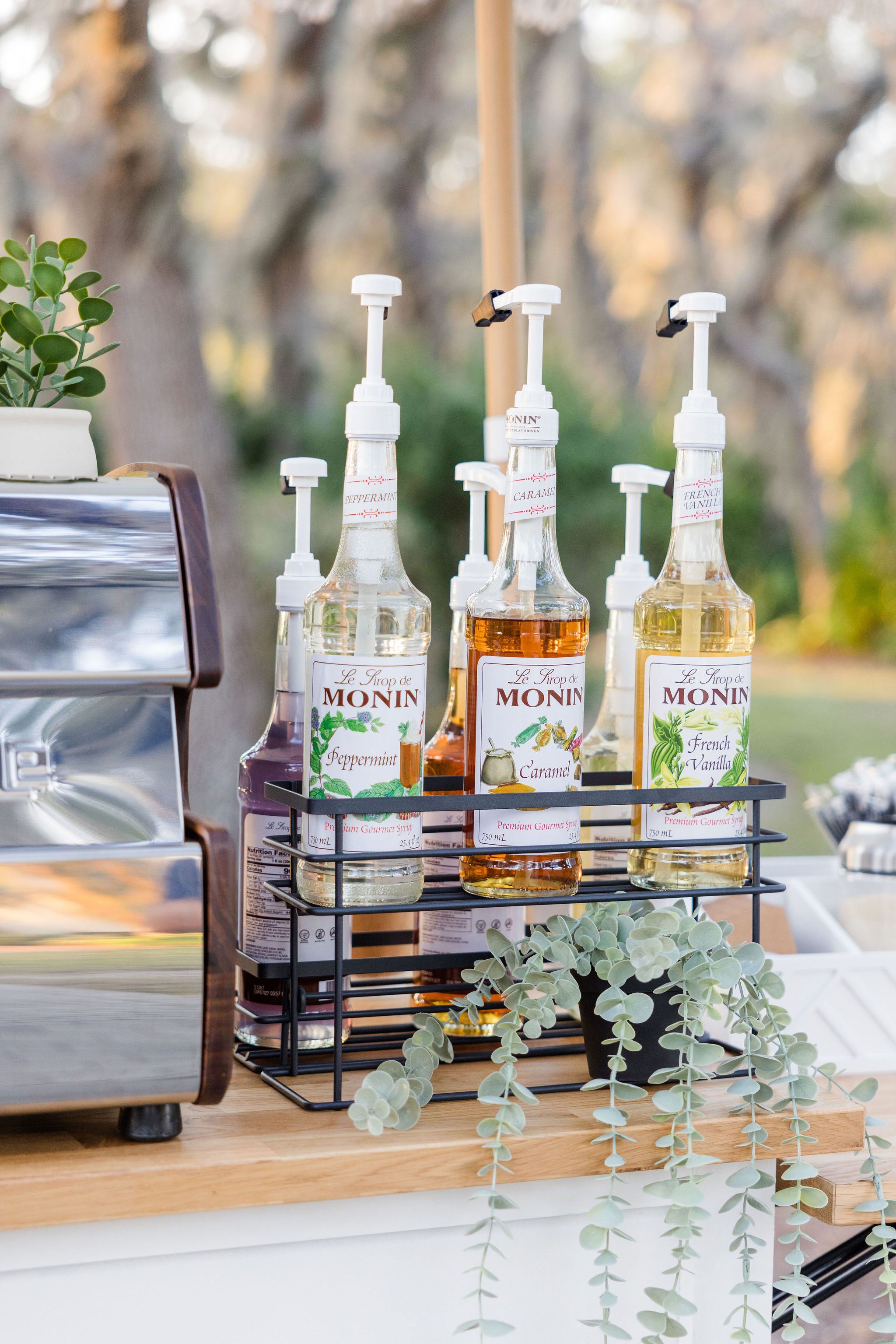 Luxury mobile coffee cart setup with fresh flowers and custom signage for a Davis Islands wedding